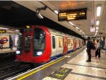 A District Line train arrives at Victoria Station